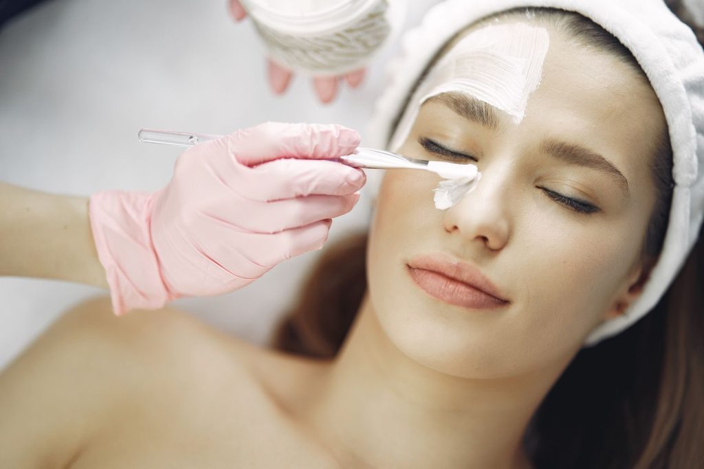 Woman relaxing during a professional aesthetic facial treatment
