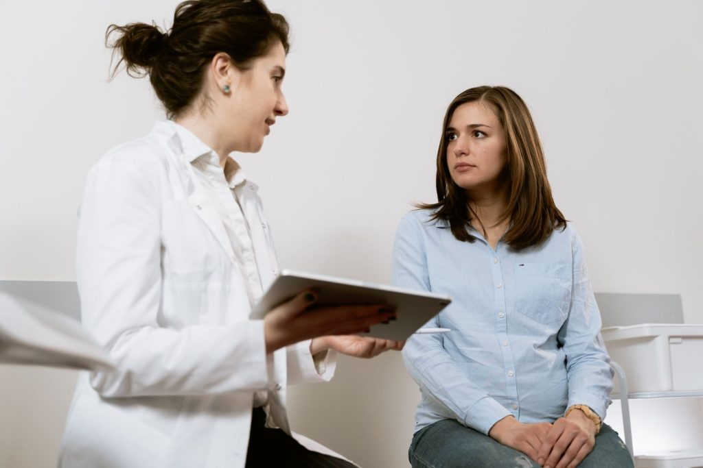 Doctor reviewing a care plan on a tablet with a patient for chronic disease management