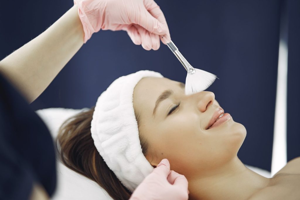 Woman receiving a professional facial skin treatment for acne scars