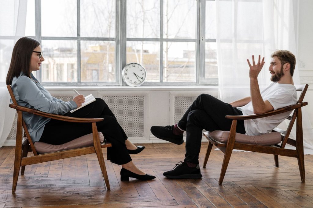 Patient talking with a therapist in a bright counseling room