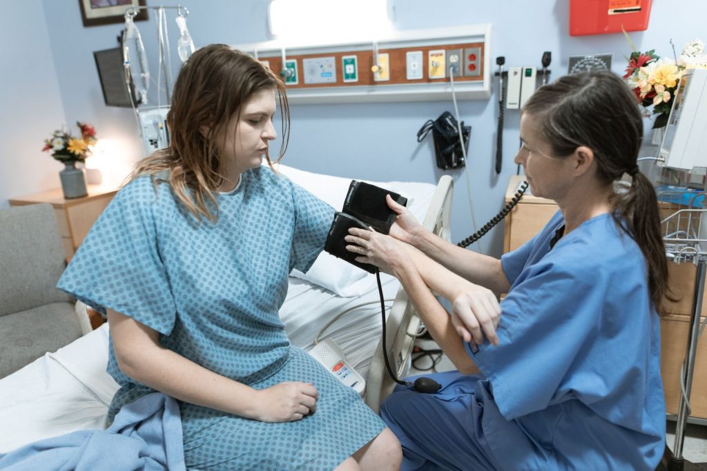 Nurse checking a patient's blood pressure during a routine physical exam